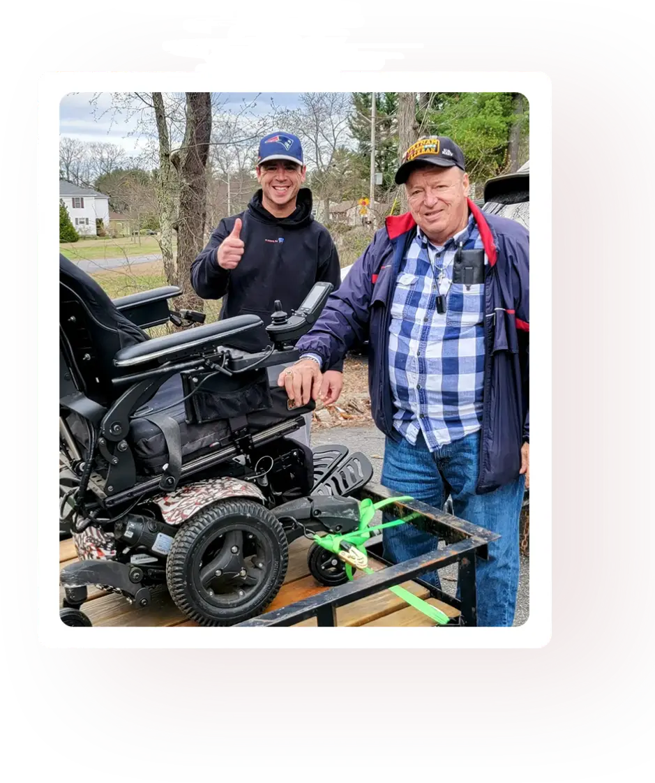 Two men standing next to a motorcycle.