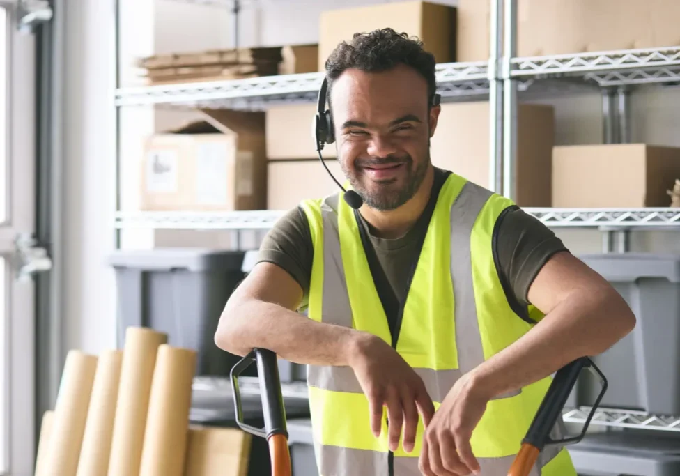A man wearing a yellow vest and headphones.